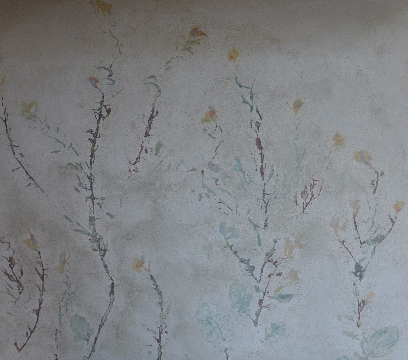 Concrete backsplash with flowers, weeds impressions with various yellows, turquoise, and pale red colors