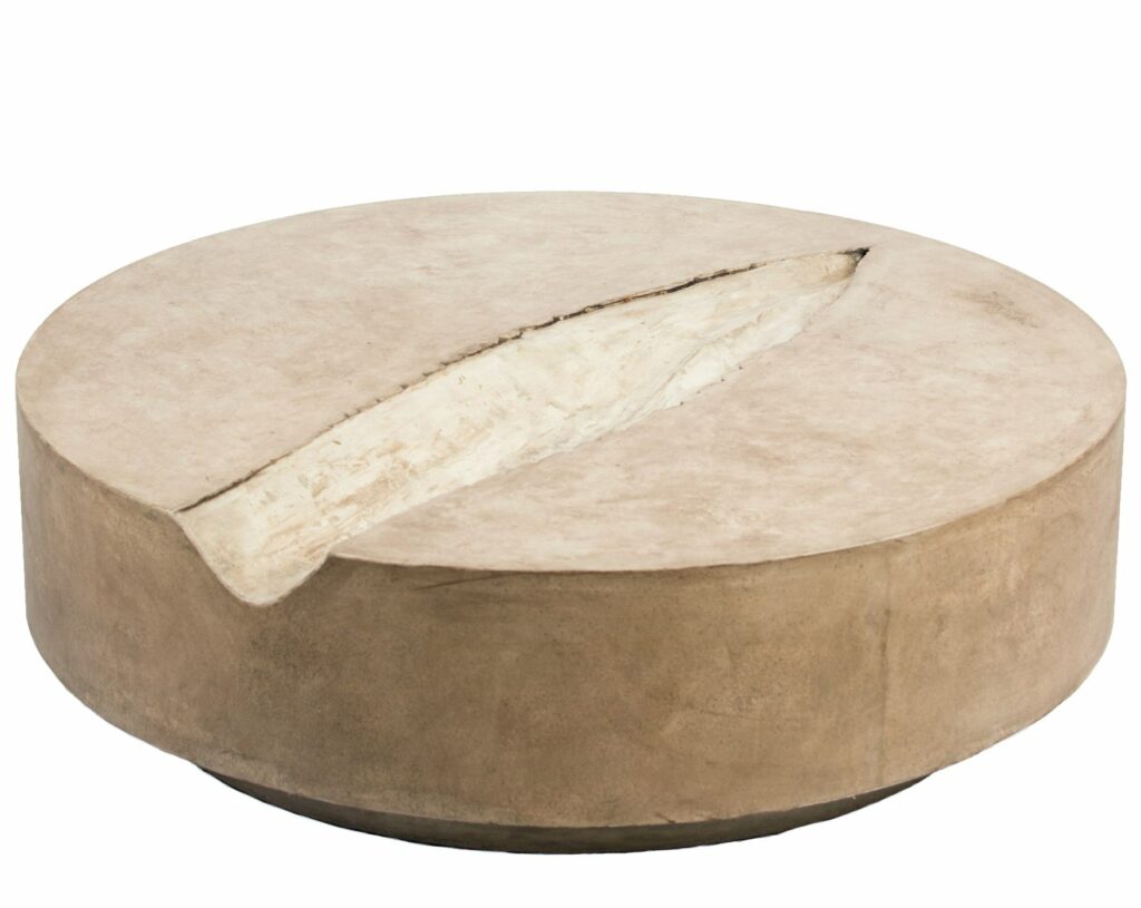 Large 40" diameter concrete coffee table with agave blade impression running through middle