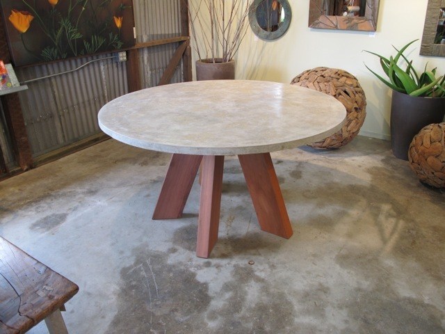 round concrete dining table with redwood base