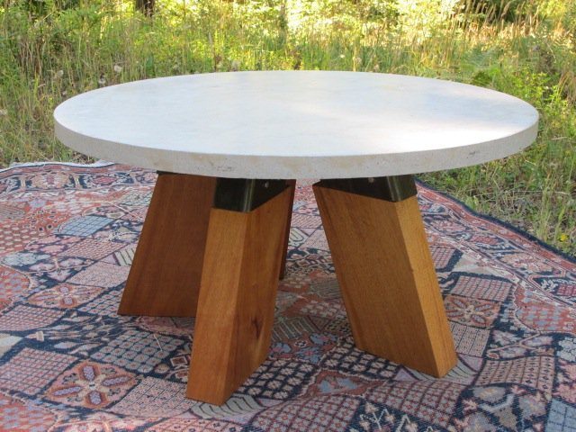 round concrete dining table with cypress wood leg base