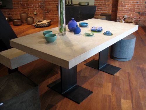 White concrete dining table top on two steel eye-beam shaped legs