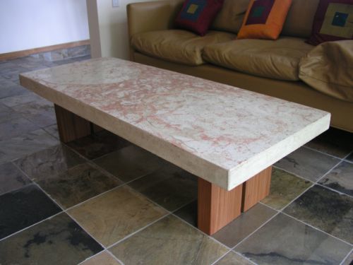Concrete top with reddish coloring on split wood base