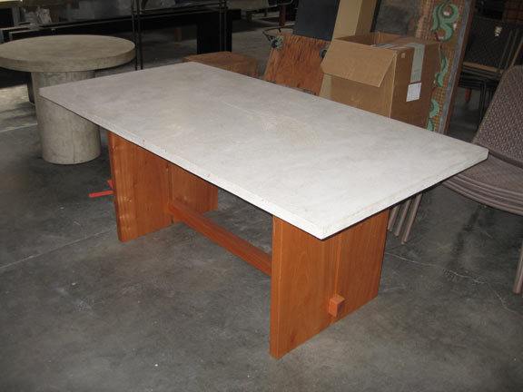 dining table with concrete top and mahogany base