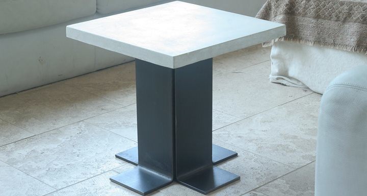 small concrete side table with steel base with flared bottom