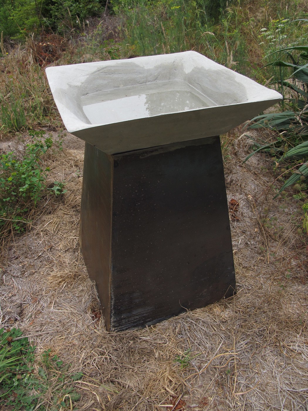 grey square concrete birdbath on steel base