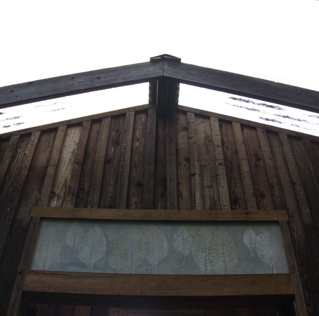 outdoor concrete panel over house entryway with tobacco leaf imprints