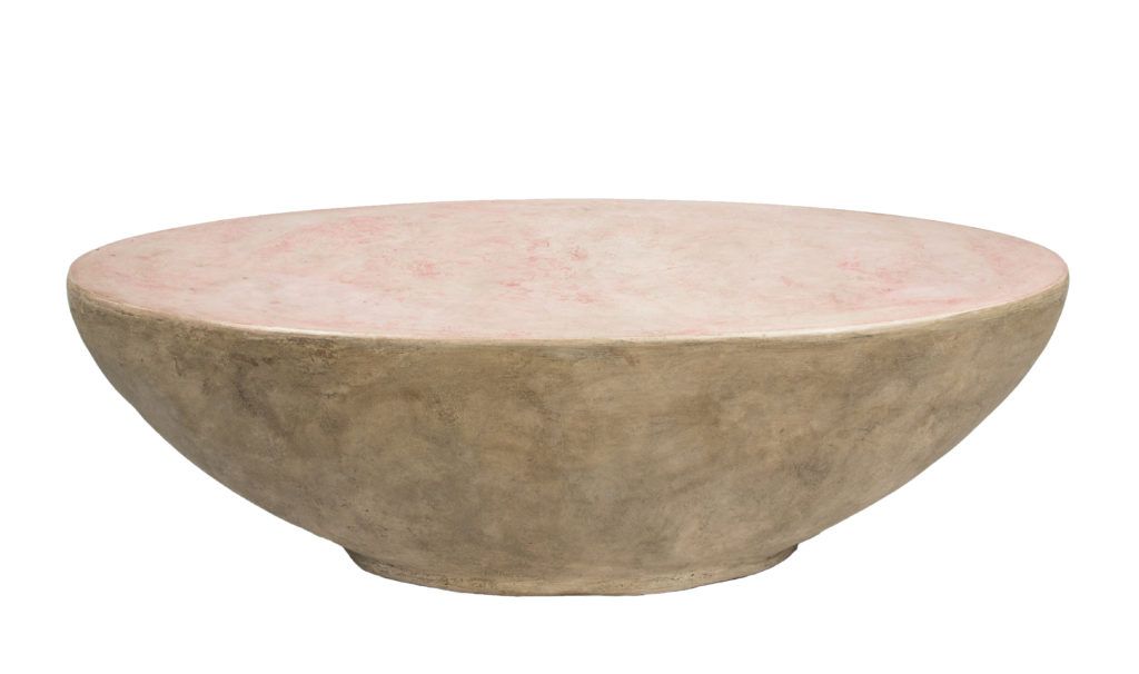 curved oval shaped concrete coffee table with pink top and brown sides