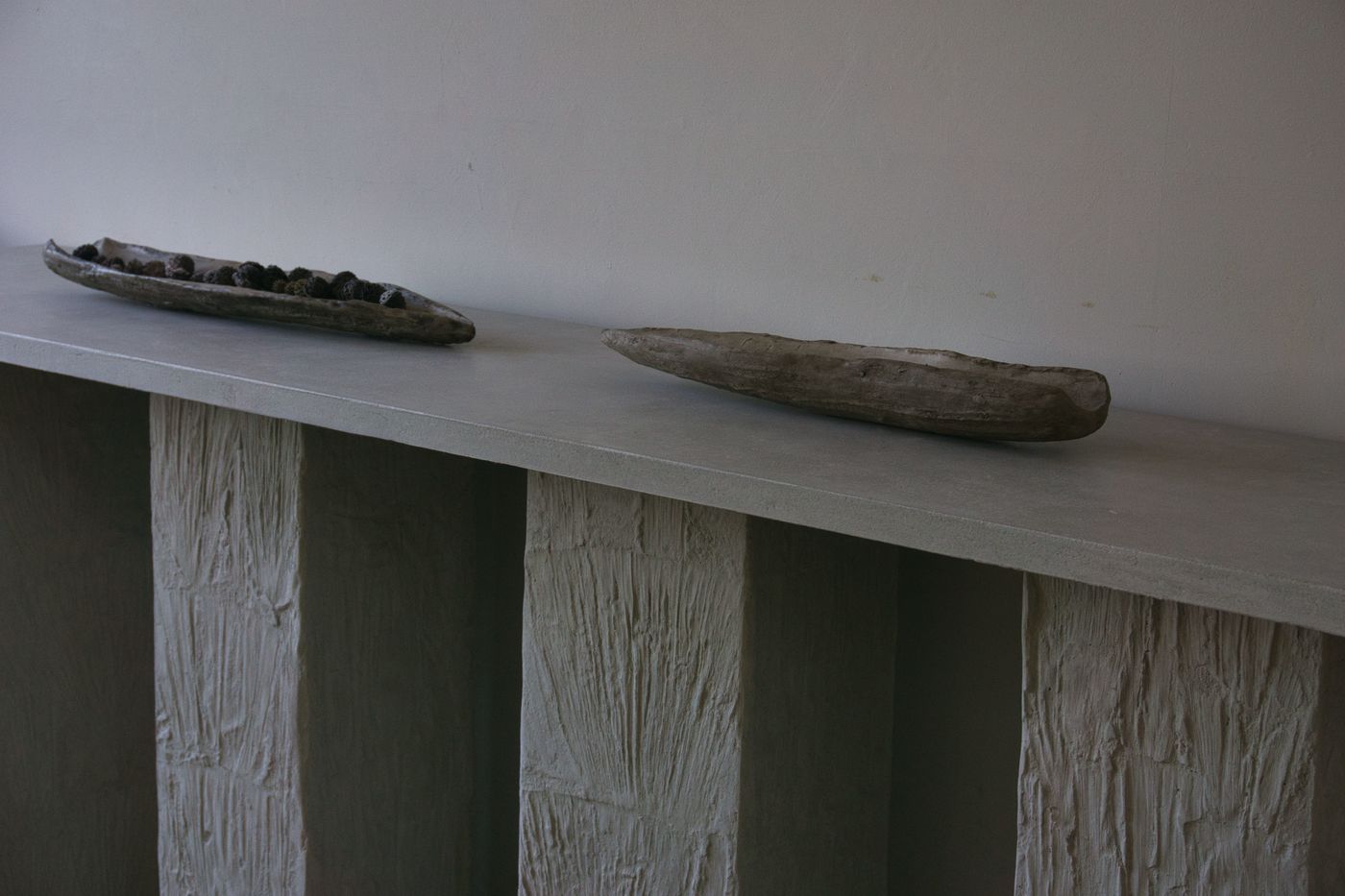 Concrete Console with Corn husk  Pillars and small concrete agave blade sculptures in grey