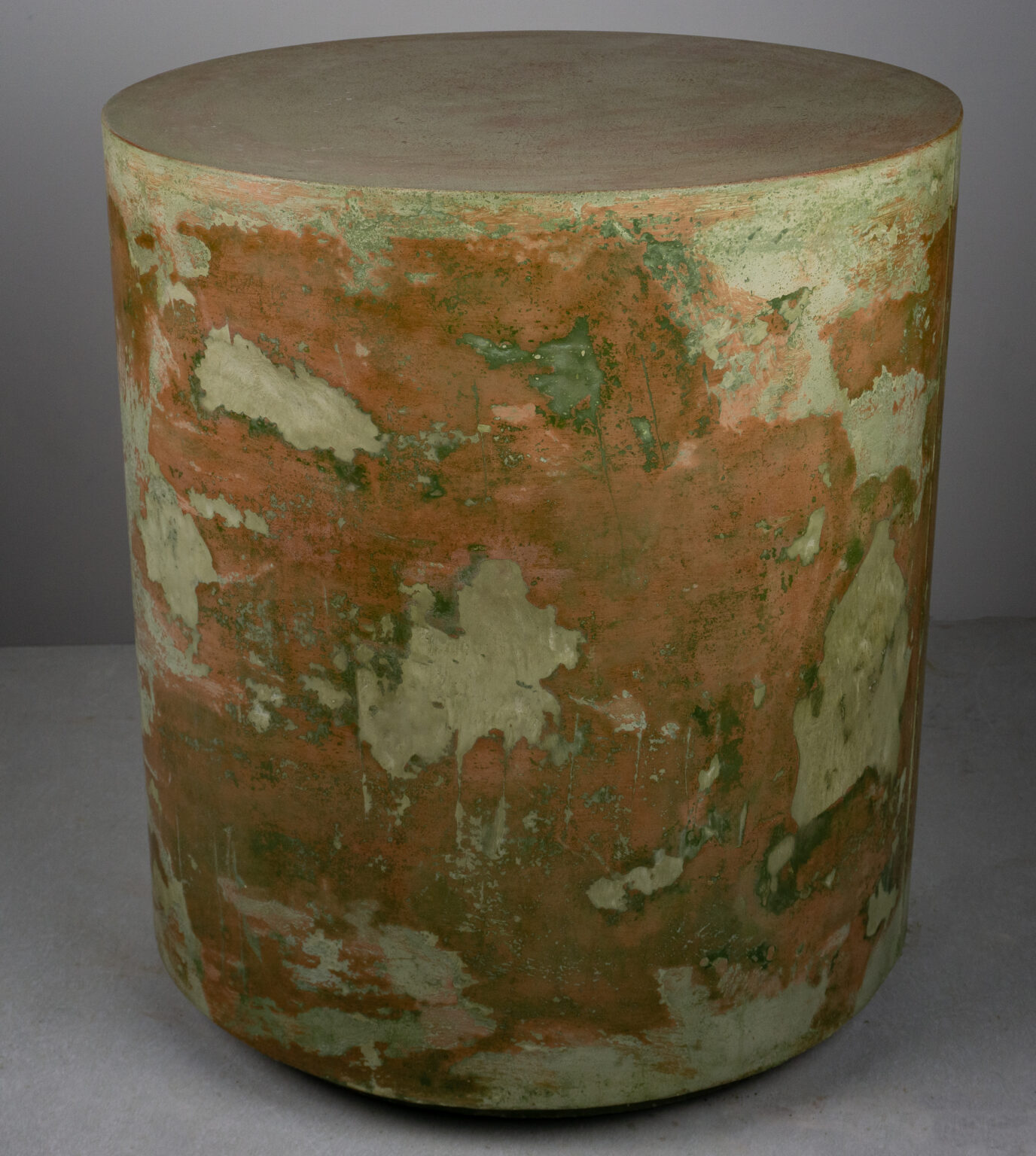 venetian plaster-like concrete side table with reds and greens, side shot