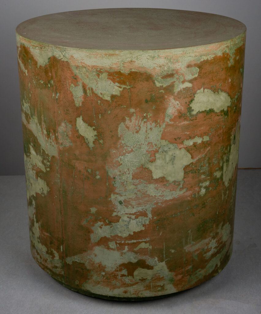 artistic, venetian plaster-like concrete side table with reds and greens, side shot
