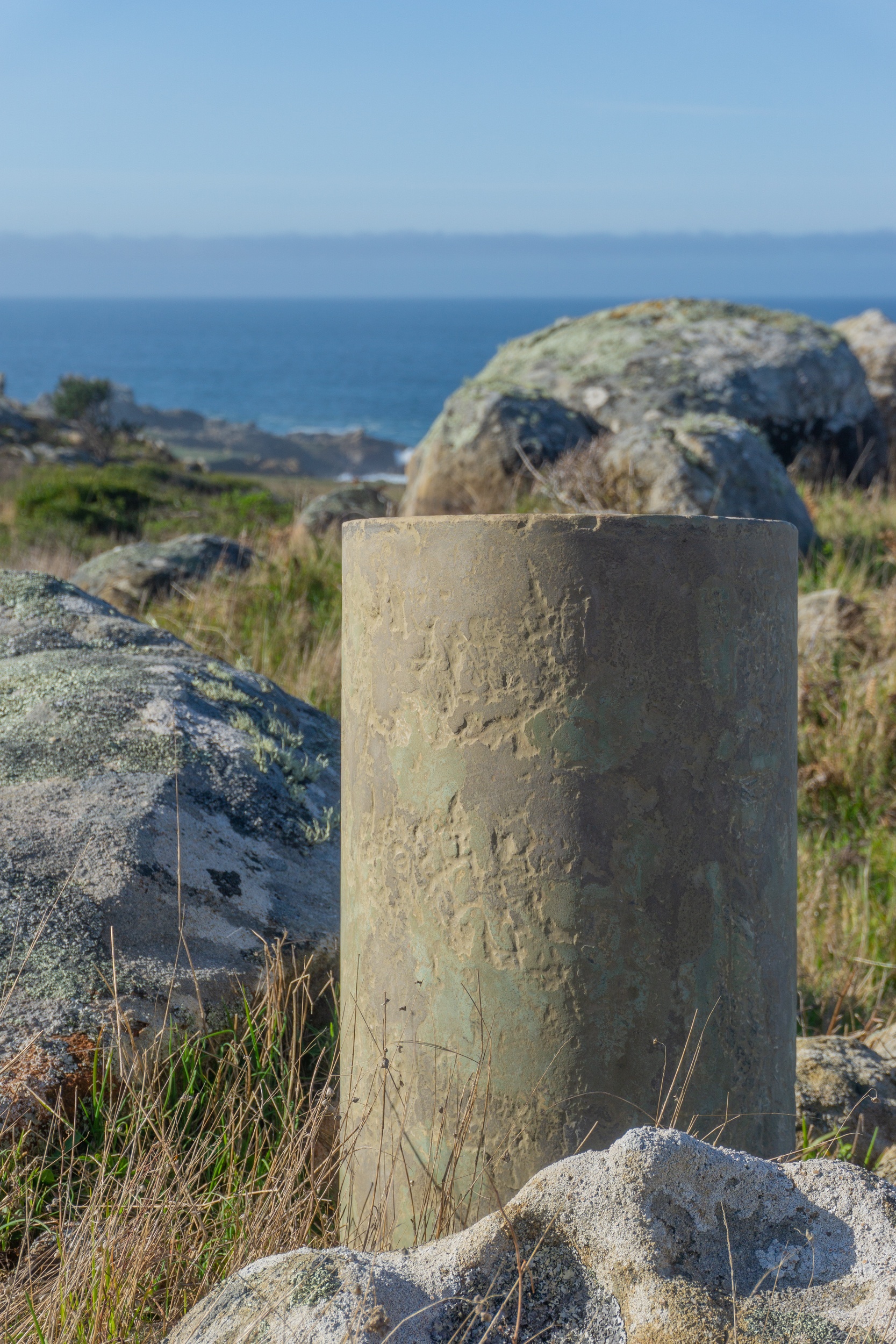 Small concrete stool in green and brown at gerstle cove bluffs
