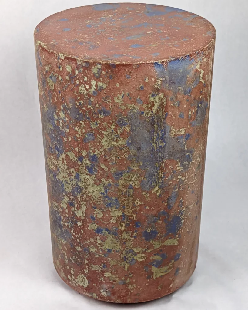 red and blue concrete side table 12" x 20" tall with Pollock-like splatter pattern