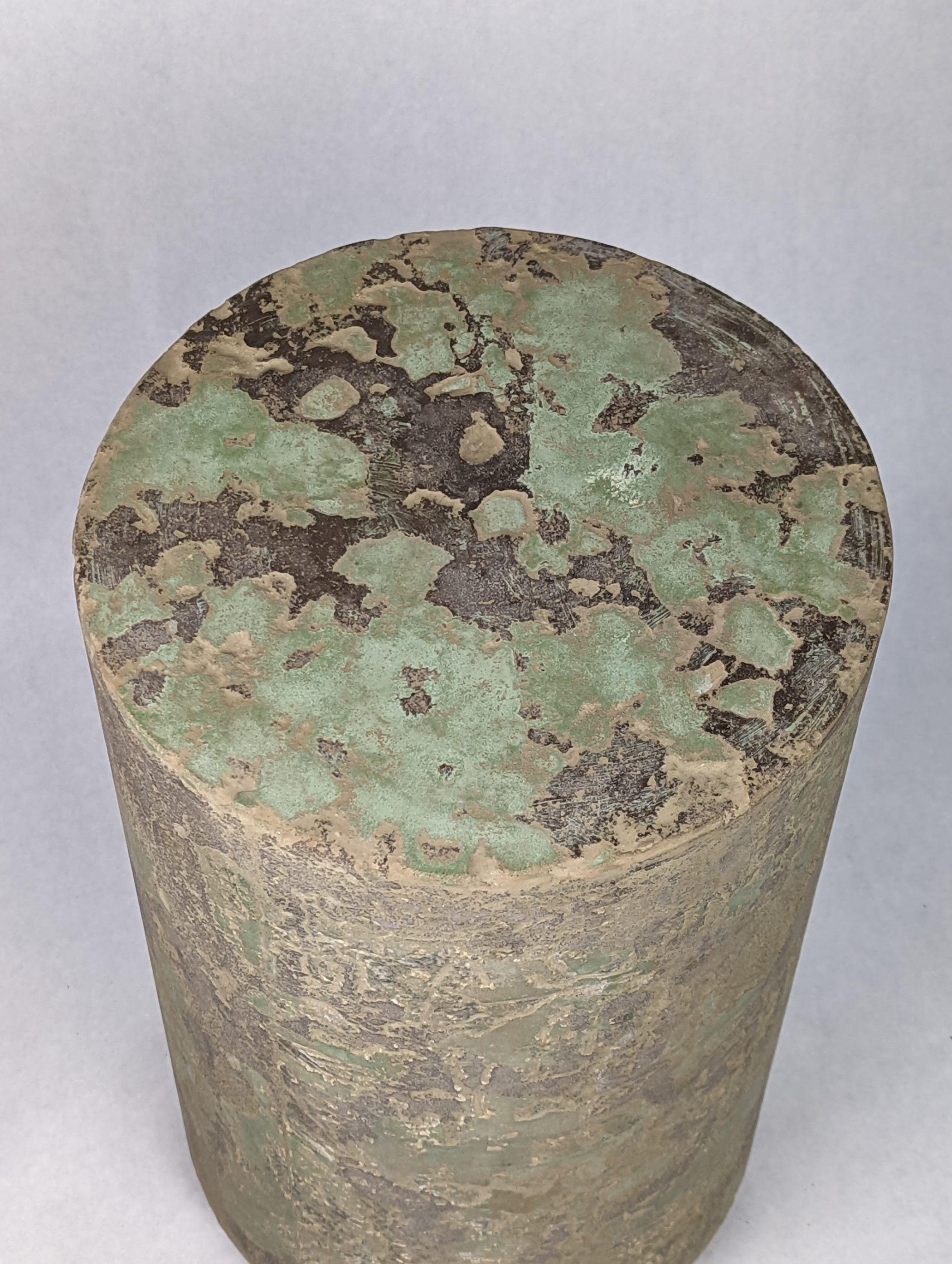 Concrete side or end table or stool with green and dark browns on top with mottled side pattern