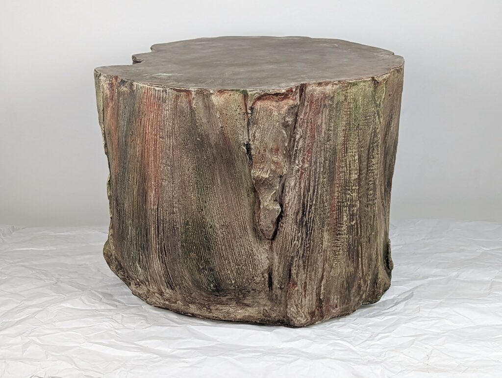 Sculptural concrete coffee table based on palm seedpod patterns, primarily brown but with subtle reds, greens and blue highlights