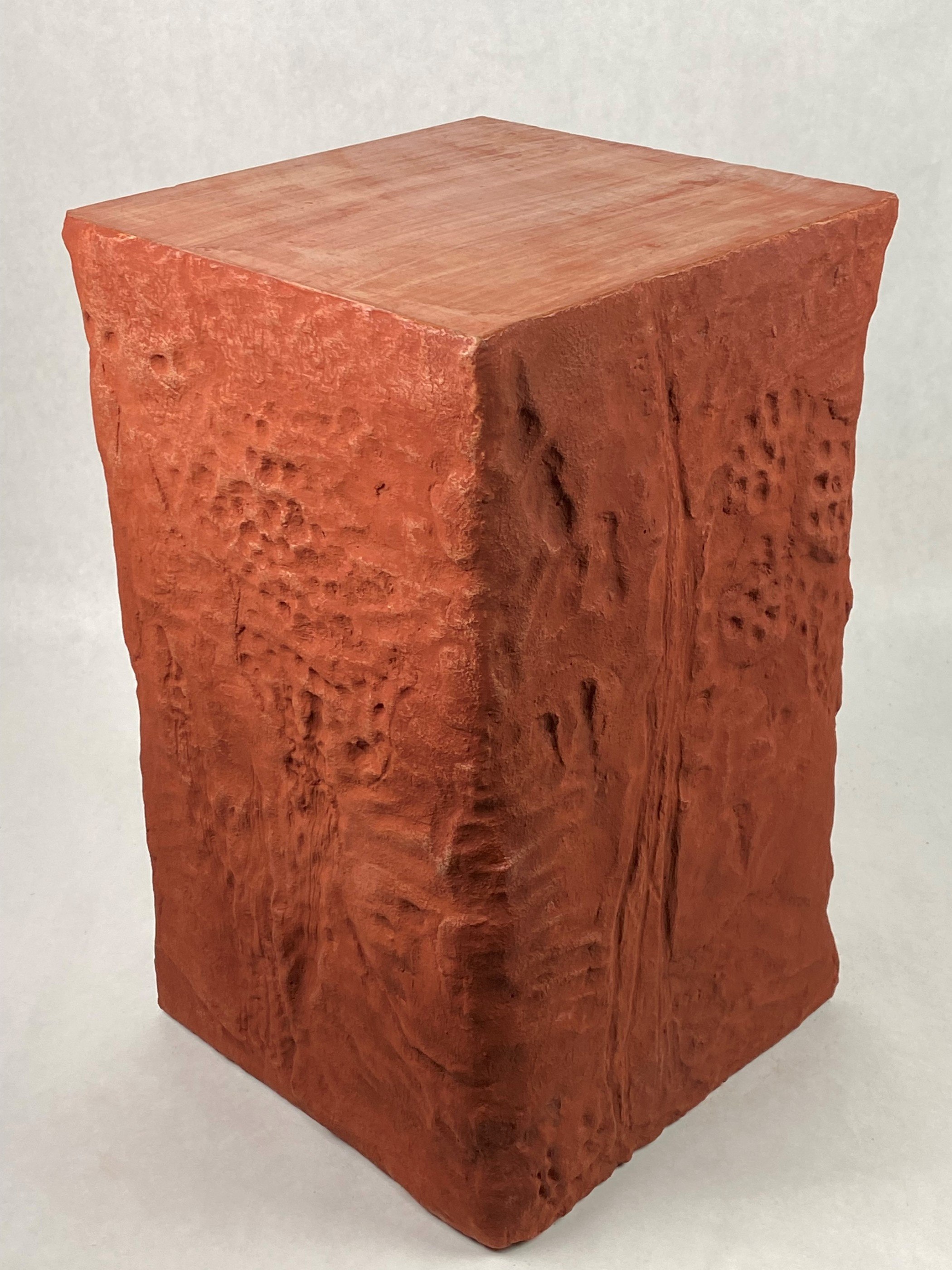 red concrete side table with textured sides