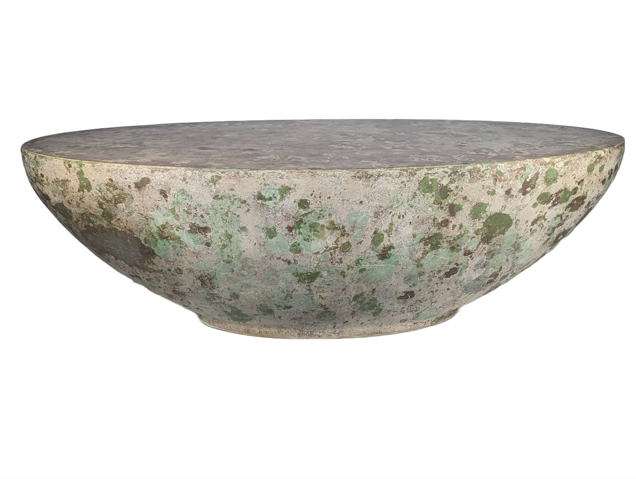 Organic oval concrete coffee table with greens and browns