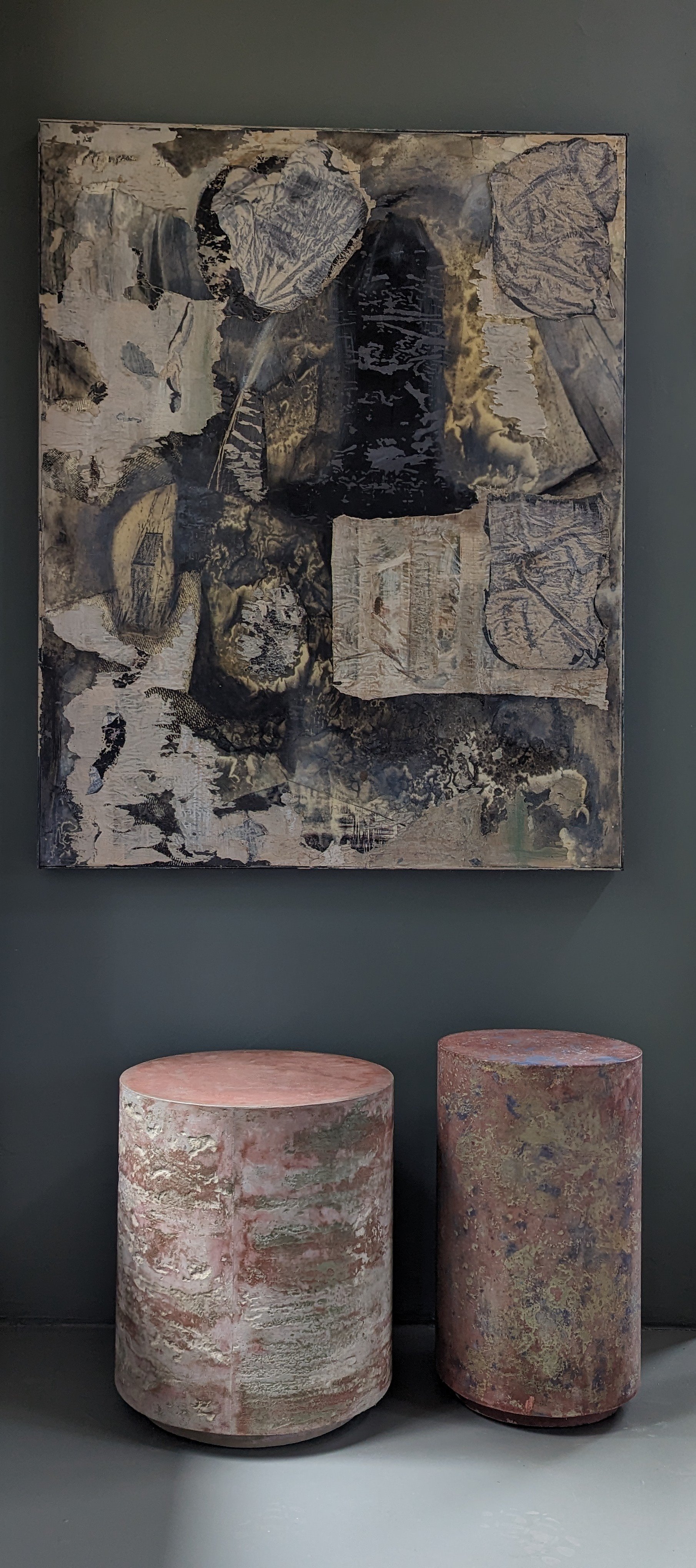 Abstract collage-like painting with two pink and green side tables below