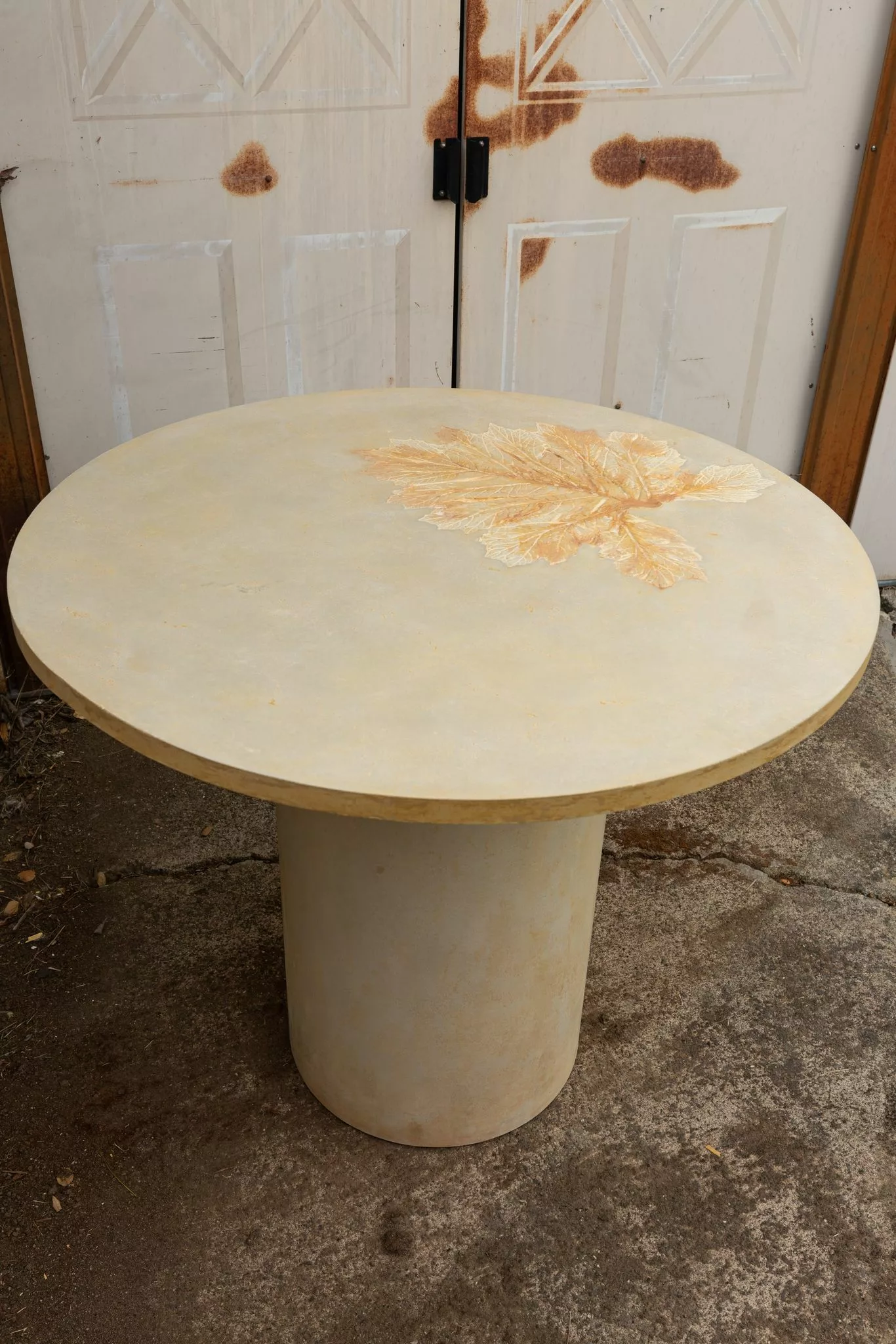 round concrete dining table of 40" diameter with Acanthus Leaf Imprint in Yellow